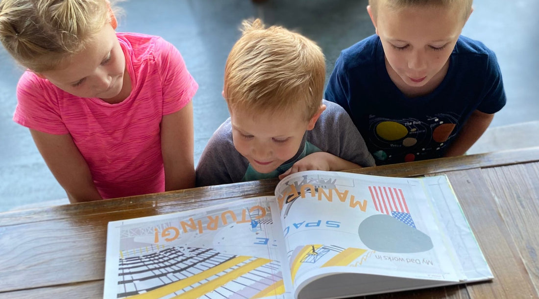 children reading the self published book, Blake Explores Manufacturing, created in full by residents of Minnesota