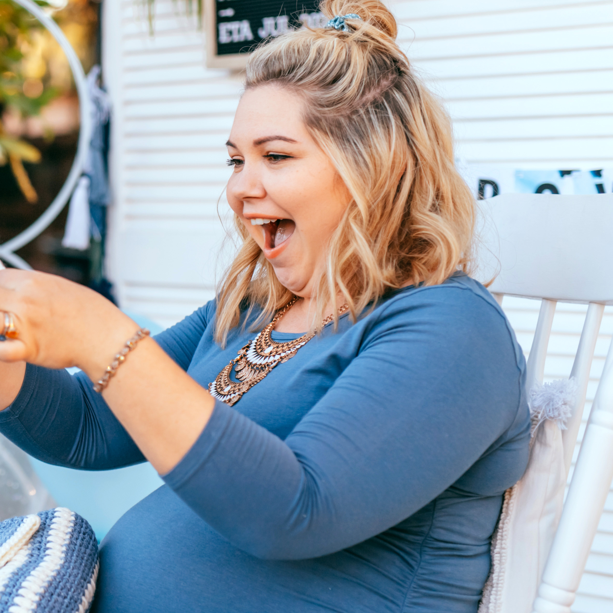 A photo of a surprised mommy to be getting a self published personalized storybook called "I'm Your Mommy."