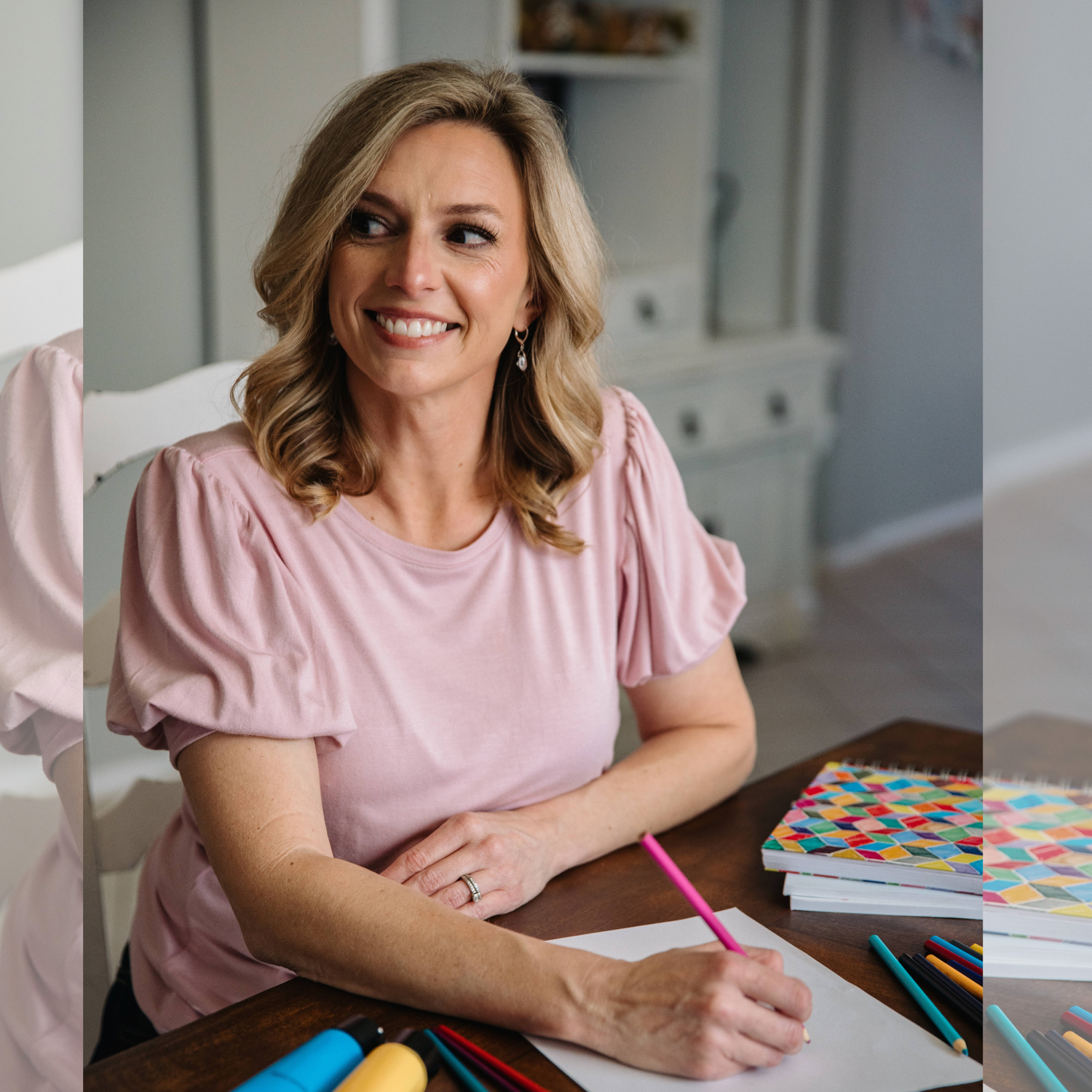 A photograph of Lindsay Dain, a self published author and illustrator through Kindle Direct Publishing and Amazon KDP holding colored pencils thinking of her next art creation.