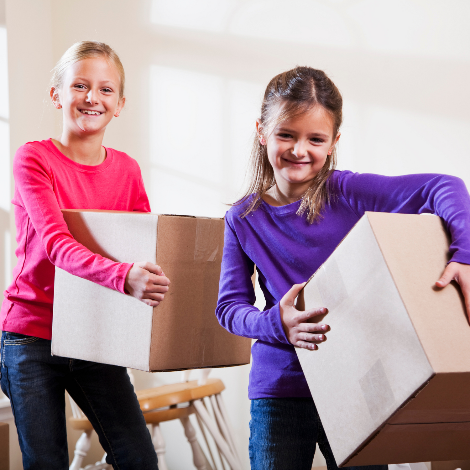 a photo of two children carrying boxes representing bulk and wholesale orders of self-published author, Lindsay Dain's creation via Amazon's KDP and Kindle Direct Publishing